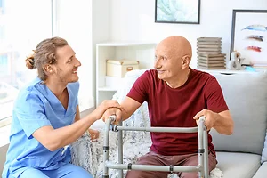 Caregiver assisting an elderly nursing home resident in a long-term care facility
